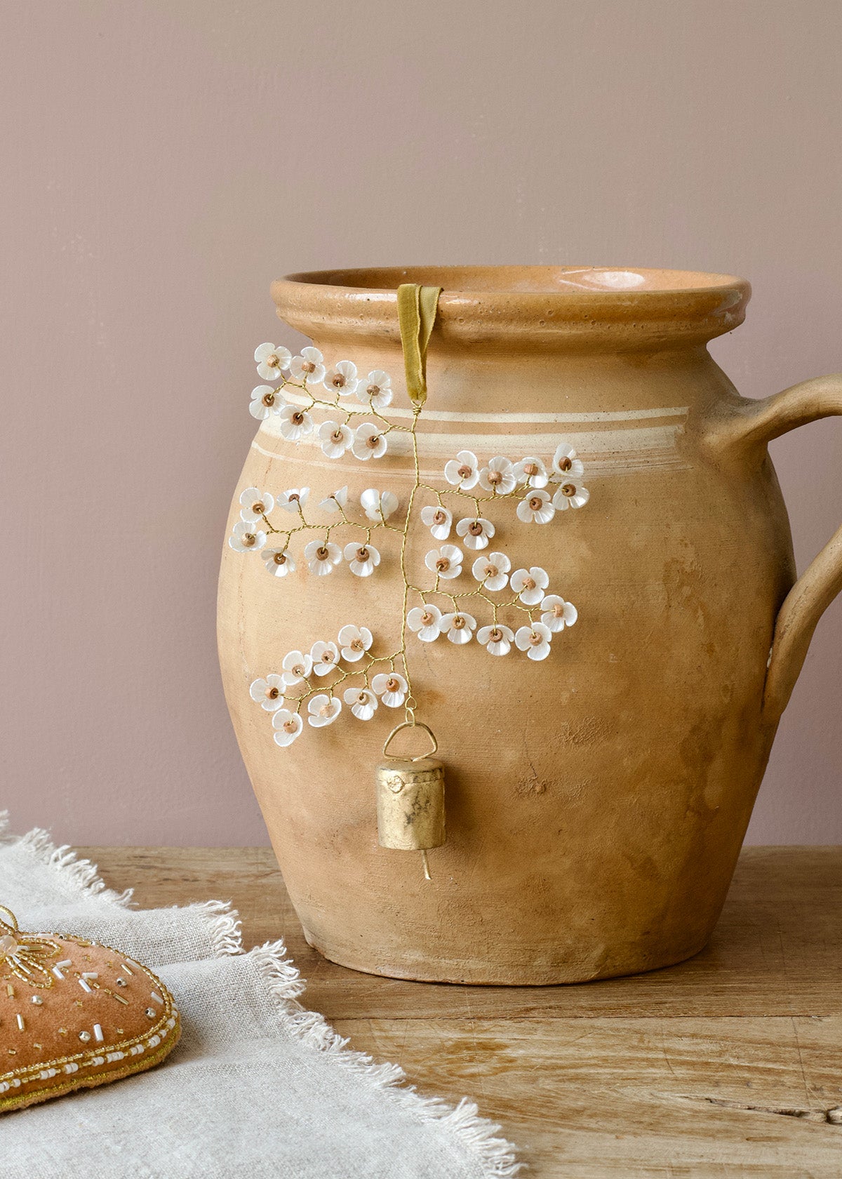 Decorative ceramic vase with floral design on a wooden surface
