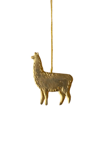Gold llama-shaped pendant on a pink background with gold stars