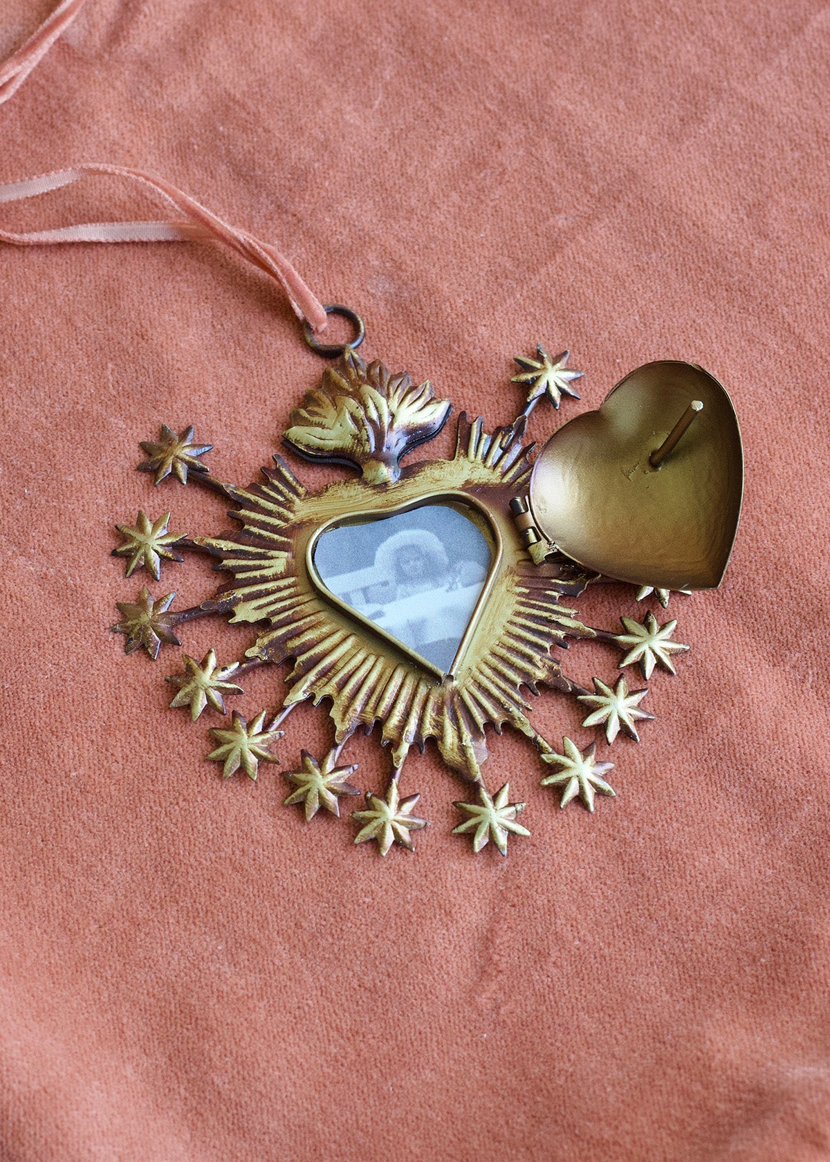 Decorative heart-shaped ornament with stars on a pink background